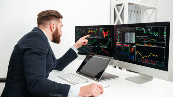 Man sitting in from of trading desk
